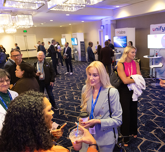 People talking with booths behind